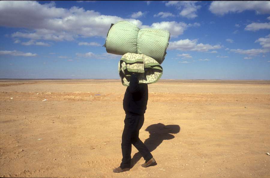 1991: Jordan/Iraq border. Refugees arriving in Jordan after Saddam Hussein's invasion of Kuwait. 1991: Jordan/Iraq border. Refugees arriving in Jordan after Saddam Hussein's invasion of Kuwait.