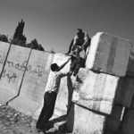 2003: Palestinian residents of Abu Dis crossing the separation barrier in E. Jerusalem. 2003: Palestinian residents of Abu Dis crossing the separation barrier in E. Jerusalem.