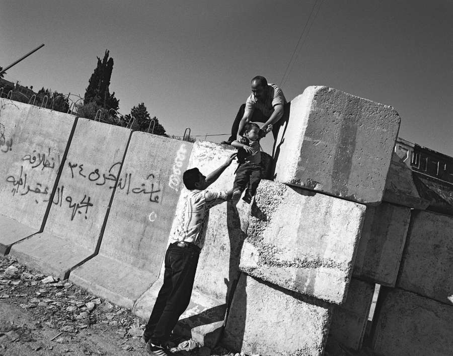 2003: Palestinian residents of Abu Dis crossing the separation barrier in E. Jerusalem. 2003: Palestinian residents of Abu Dis crossing the separation barrier in E. Jerusalem.